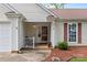 Close up of front entrance featuring a covered porch, painted door, and a manicured garden at 510 Sw Viking Sw Pl, Concord, NC 28025