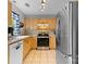 Traditional kitchen with stainless steel appliances, tile floors, and light wood cabinets at 510 Sw Viking Sw Pl, Concord, NC 28025