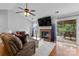 Cozy living room with hardwood floors, a brick fireplace, and access to the back patio at 510 Sw Viking Sw Pl, Concord, NC 28025