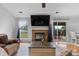 Spacious living room featuring a brick fireplace, a sliding glass door, and hardwood floors at 510 Sw Viking Sw Pl, Concord, NC 28025