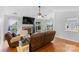 Bright living room featuring a brick fireplace, hardwood floors, sliding glass doors, and open space at 510 Sw Viking Sw Pl, Concord, NC 28025