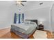 Spacious main bedroom with tray ceilings, neutral walls and curtains, and wood flooring at 510 Sw Viking Sw Pl, Concord, NC 28025