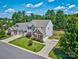 View of a two-story home with manicured lawn, trees, driveway, and neighboring houses at 511 Rough Hewn Ln, Rock Hill, SC 29730