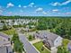 Neighborhood view showing community pool, lush trees, landscaped lawns, and well-maintained streets at 511 Rough Hewn Ln, Rock Hill, SC 29730