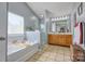 Bathroom featuring a soaking tub, walk-in shower, and double vanity at 511 Rough Hewn Ln, Rock Hill, SC 29730