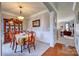 View of a formal dining room with wainscoting, chandelier, and entry to living room at 511 Rough Hewn Ln, Rock Hill, SC 29730