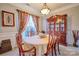 Formal dining room with wainscoting, elegant furniture, and a decorative hutch at 511 Rough Hewn Ln, Rock Hill, SC 29730