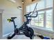 Well-lit exercise area with a Peloton and view of outdoors at 511 Rough Hewn Ln, Rock Hill, SC 29730