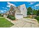 Exterior view of home featuring a driveway, basketball hoop, and manicured lawn at 511 Rough Hewn Ln, Rock Hill, SC 29730