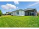 Landscaped backyard showcases a well-manicured lawn and the home's exterior, creating a serene oasis at 6277 Raven Rock Dr, Denver, NC 28037