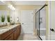 Bathroom vanity with double sinks, granite countertops, and a black framed glass door shower at 6277 Raven Rock Dr, Denver, NC 28037