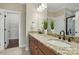 Bathroom with double vanity, granite countertops, and a mirror in a neutral color palette at 6277 Raven Rock Dr, Denver, NC 28037
