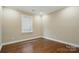 An empty bedroom with hardwood floors and neutral colored walls at 6277 Raven Rock Dr, Denver, NC 28037