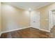 Spacious empty bedroom featuring hardwood floors, crown molding, and a closet at 6277 Raven Rock Dr, Denver, NC 28037