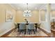 Dining room features a wooden table with seating for six, a modern chandelier, and warm paint color at 6277 Raven Rock Dr, Denver, NC 28037