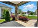 Inviting front porch with stone columns, trim detail and a view of the landscaped front yard at 6277 Raven Rock Dr, Denver, NC 28037