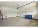 Open two-car garage with epoxy flooring, a utility sink, and two large trash bins at 6277 Raven Rock Dr, Denver, NC 28037