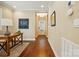 Hallway featuring hardwood floors, neutral paint, and views of the front door and adjacent room at 6277 Raven Rock Dr, Denver, NC 28037