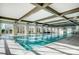 Bright indoor pool featuring vaulted ceilings, large windows, and ample space for swimming and recreation at 6277 Raven Rock Dr, Denver, NC 28037