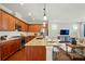 Modern kitchen featuring a granite island, stainless steel appliances, and hardwood floors that open to the living room at 6277 Raven Rock Dr, Denver, NC 28037