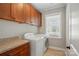 Laundry room with washer, dryer, granite counter and wood cabinets above at 6277 Raven Rock Dr, Denver, NC 28037