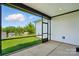 Covered patio offers a screened-in view of the landscaped backyard, blending indoor/outdoor living at 6277 Raven Rock Dr, Denver, NC 28037