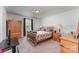 Comfortable bedroom with neutral carpeting, natural wood furniture, and a window for natural light at 635 Scarlet Leaf Ln, Oakboro, NC 28129