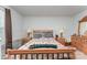 Bright bedroom featuring a wooden bed frame, matching dresser, and two side tables with lamps at 635 Scarlet Leaf Ln, Oakboro, NC 28129