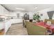 Open concept kitchen with white cabinetry, stainless steel appliances, and view to the adjacent dining area at 635 Scarlet Leaf Ln, Oakboro, NC 28129