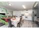 Bright kitchen with white cabinets, granite countertops, stainless steel refrigerator and an adjacent dining area at 635 Scarlet Leaf Ln, Oakboro, NC 28129