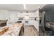 Bright kitchen with white cabinets, granite countertops, stainless steel refrigerator and adjacent dining area at 635 Scarlet Leaf Ln, Oakboro, NC 28129