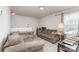 Inviting living room featuring comfortable sofas, a table lamp, neutral walls, and carpeted flooring at 635 Scarlet Leaf Ln, Oakboro, NC 28129