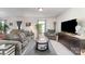 Comfortable living room features plush gray furniture, a large TV, and a cozy atmosphere for relaxation at 635 Scarlet Leaf Ln, Oakboro, NC 28129