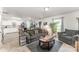 Inviting living room with gray sofa set, complemented by natural light and open layout with view of dining area at 635 Scarlet Leaf Ln, Oakboro, NC 28129