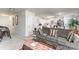 Living room featuring open floorplan with a gray sofa, view into the kitchen, and a casual seating arrangement at 635 Scarlet Leaf Ln, Oakboro, NC 28129