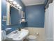 Charming blue bathroom with a sink, mirror, wainscoting, and shower with curtain at 660 Ideal Way, Charlotte, NC 28203