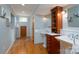 The bathroom features double sinks with tile backsplash, vanity, and hardwood floors at 660 Ideal Way, Charlotte, NC 28203