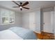 This bedroom features a ceiling fan, a window with blinds, and hardwood floors at 660 Ideal Way, Charlotte, NC 28203