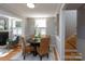 Open-concept dining area with hardwood floors, a round table, and seamlessly connected to the living room at 660 Ideal Way, Charlotte, NC 28203