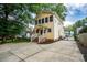 Two-story home features a spacious driveway, fenced yard, and potential for outdoor activities at 660 Ideal Way, Charlotte, NC 28203