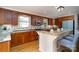 Well-lit kitchen featuring granite countertops, wood cabinetry, modern appliances, and a convenient breakfast bar at 660 Ideal Way, Charlotte, NC 28203