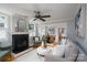 Bright living room featuring a cozy fireplace, hardwood floors, ceiling fan and neutral tones at 660 Ideal Way, Charlotte, NC 28203