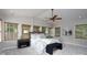 This main bedroom features a ceiling fan, bench, and multiple windows providing natural light at 660 Ideal Way, Charlotte, NC 28203