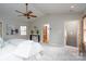 This main bedroom features a ceiling fan, high ceilings, and access to the bathroom and stairs at 660 Ideal Way, Charlotte, NC 28203