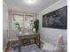 This office features a desk, chairs, a large map, and natural light at 660 Ideal Way, Charlotte, NC 28203