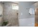 Attractive shower with neutral tile, shower seat, and a window for natural light at 660 Ideal Way, Charlotte, NC 28203