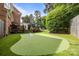 The house features a putting green, along with a spacious deck, beautiful landscaping, and outdoor entertaining areas at 6916 Cameron Glen Dr, Charlotte, NC 28210
