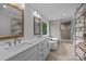 A modern bathroom with double sinks, white cabinets, a soaking tub, and a glass shower at 6916 Cameron Glen Dr, Charlotte, NC 28210