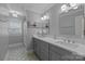 Bathroom with a long vanity, double sinks, and patterned tile floors at 6916 Cameron Glen Dr, Charlotte, NC 28210