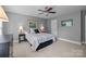 A bedroom with neutral gray walls and a ceiling fan, featuring matching lamps on side tables at 6916 Cameron Glen Dr, Charlotte, NC 28210